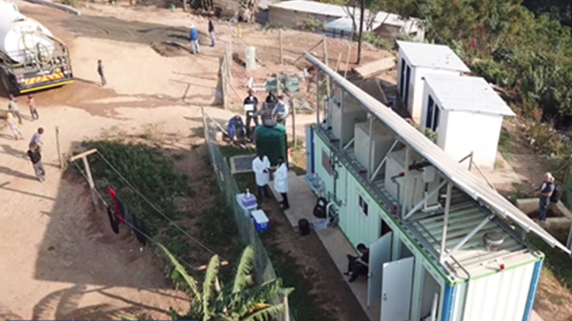 A facility in Durban, South Africa, constructed from shipping containers with multiple rooms, people engaged in various activities.