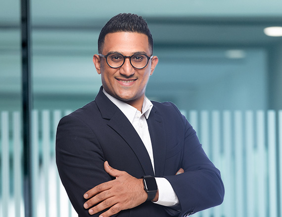 Abdulkarem Aqlan: A man in a suit looks confidently into the camera.